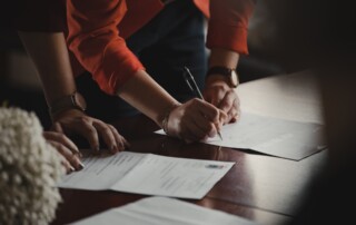 a legal person filling out a paper with a pen on a desk